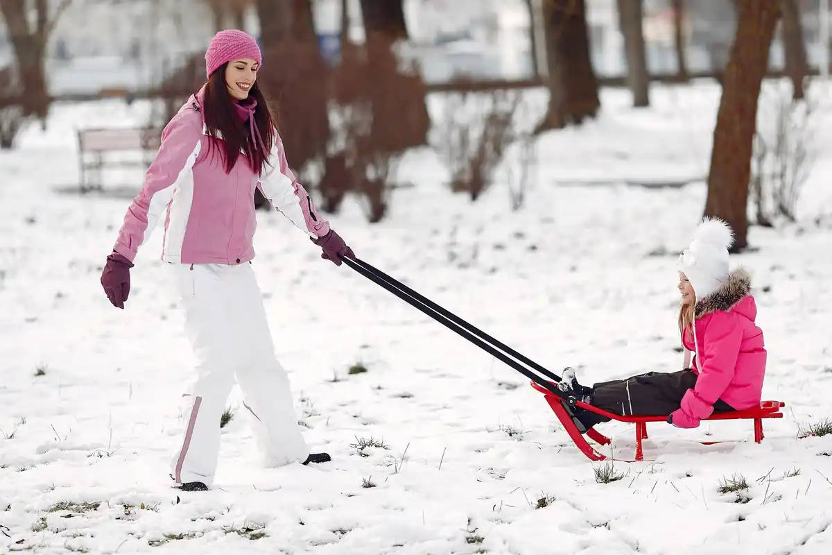 Lawn mower left outside in winter snow Czech backyard