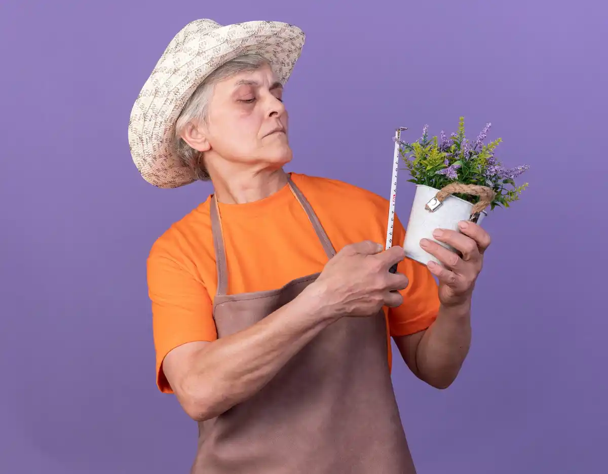 Czech grandmother holding homegrown kiwi on balcony