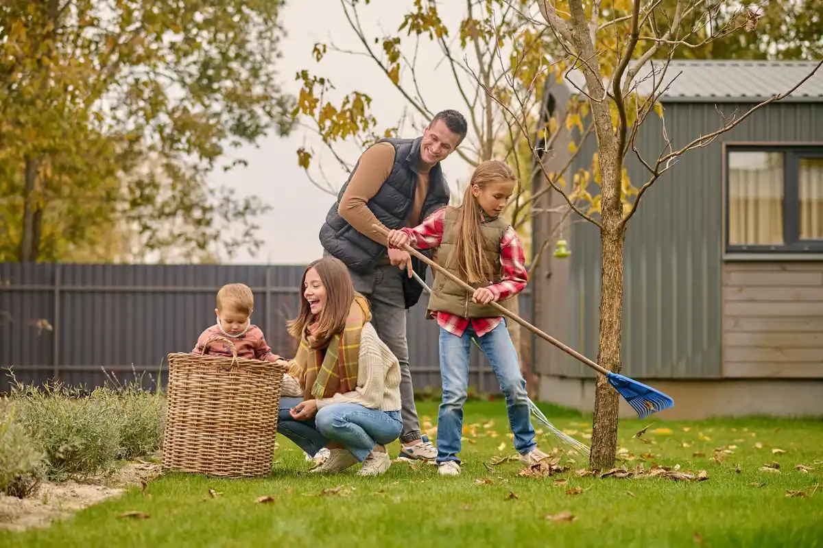 czech family fertilizing spring lawn