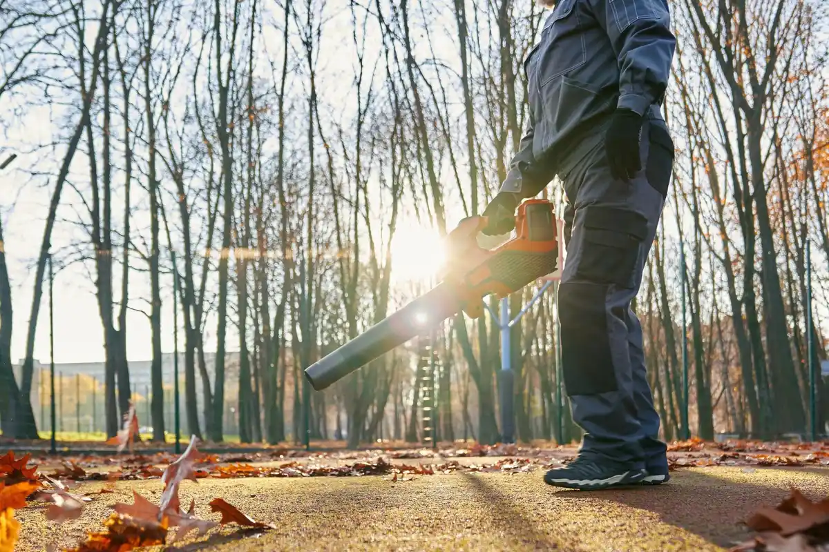 Czech gardener spreading autumn fertilizer