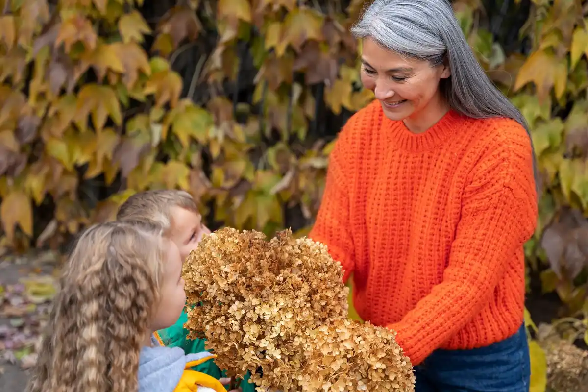 grandma using natural fertilizer in czech garden