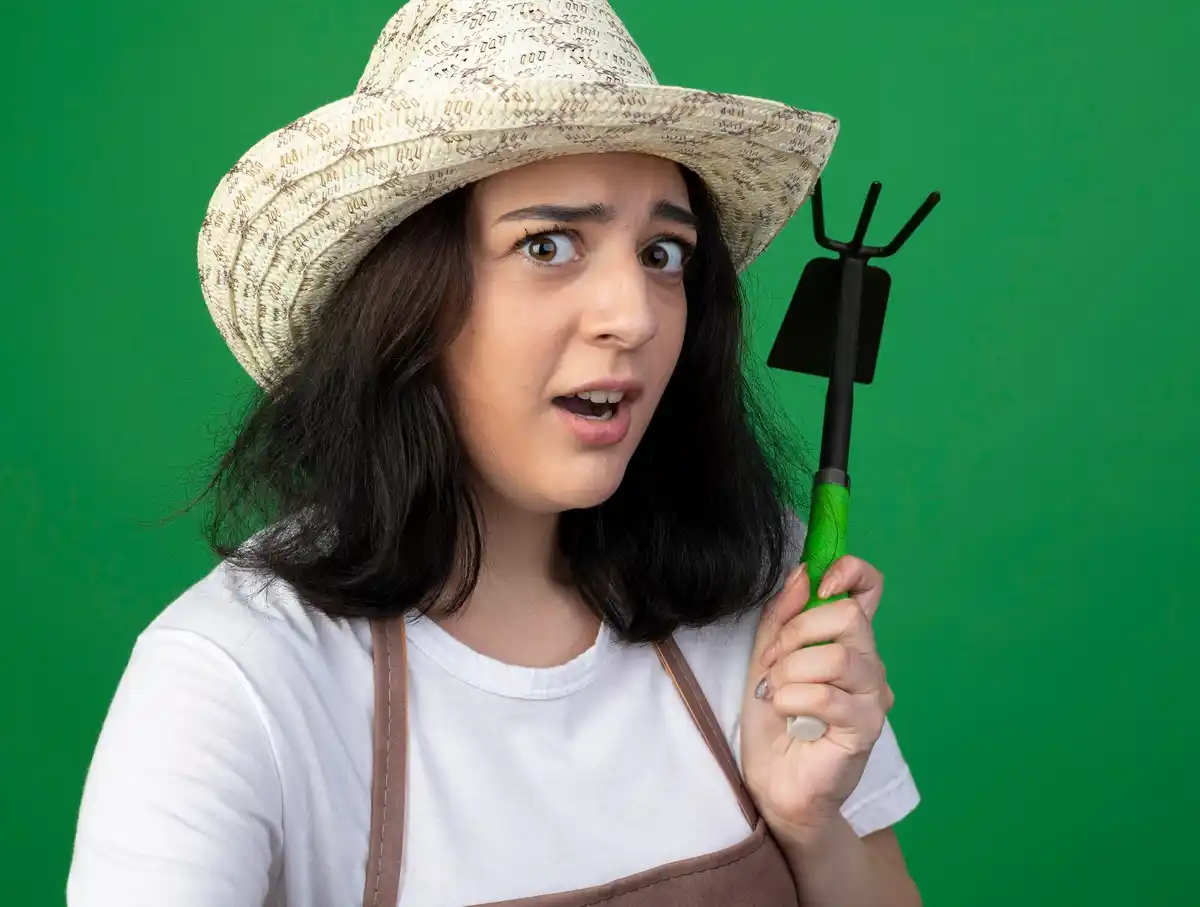 young gardener using modern hand cultivator