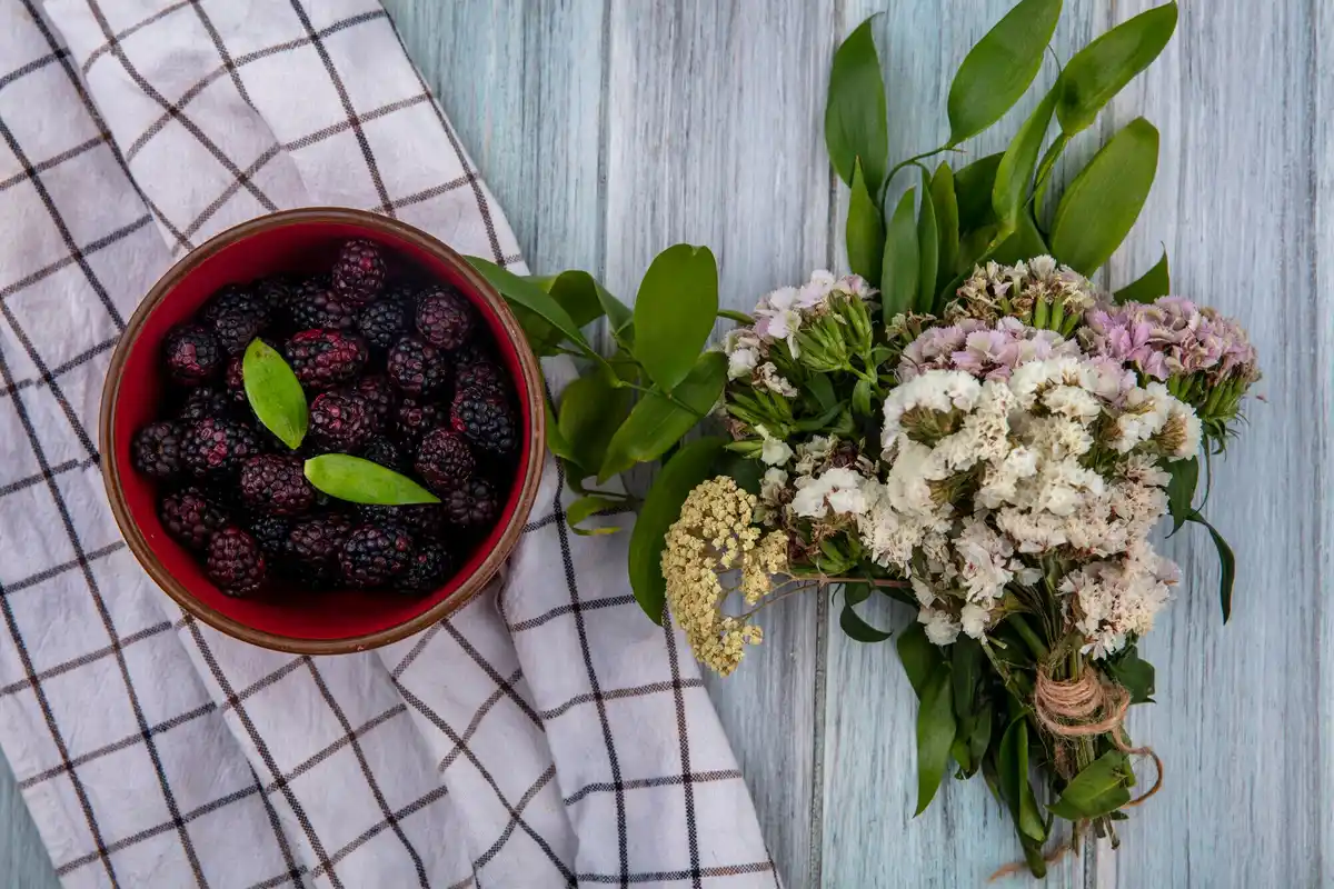 fresh edible flowers harvest on wooden table