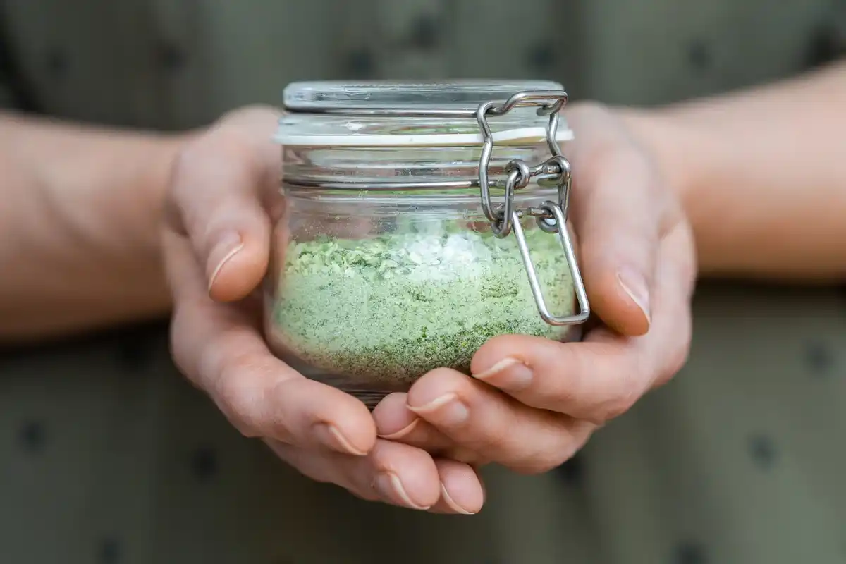 closeup hands testing garden soil vinegar baking soda Czech garden