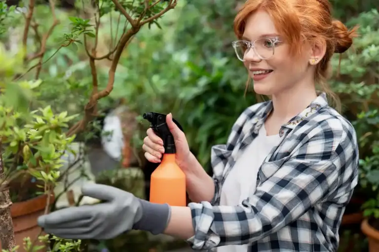 watering plants with plastic bottle Czech garden
